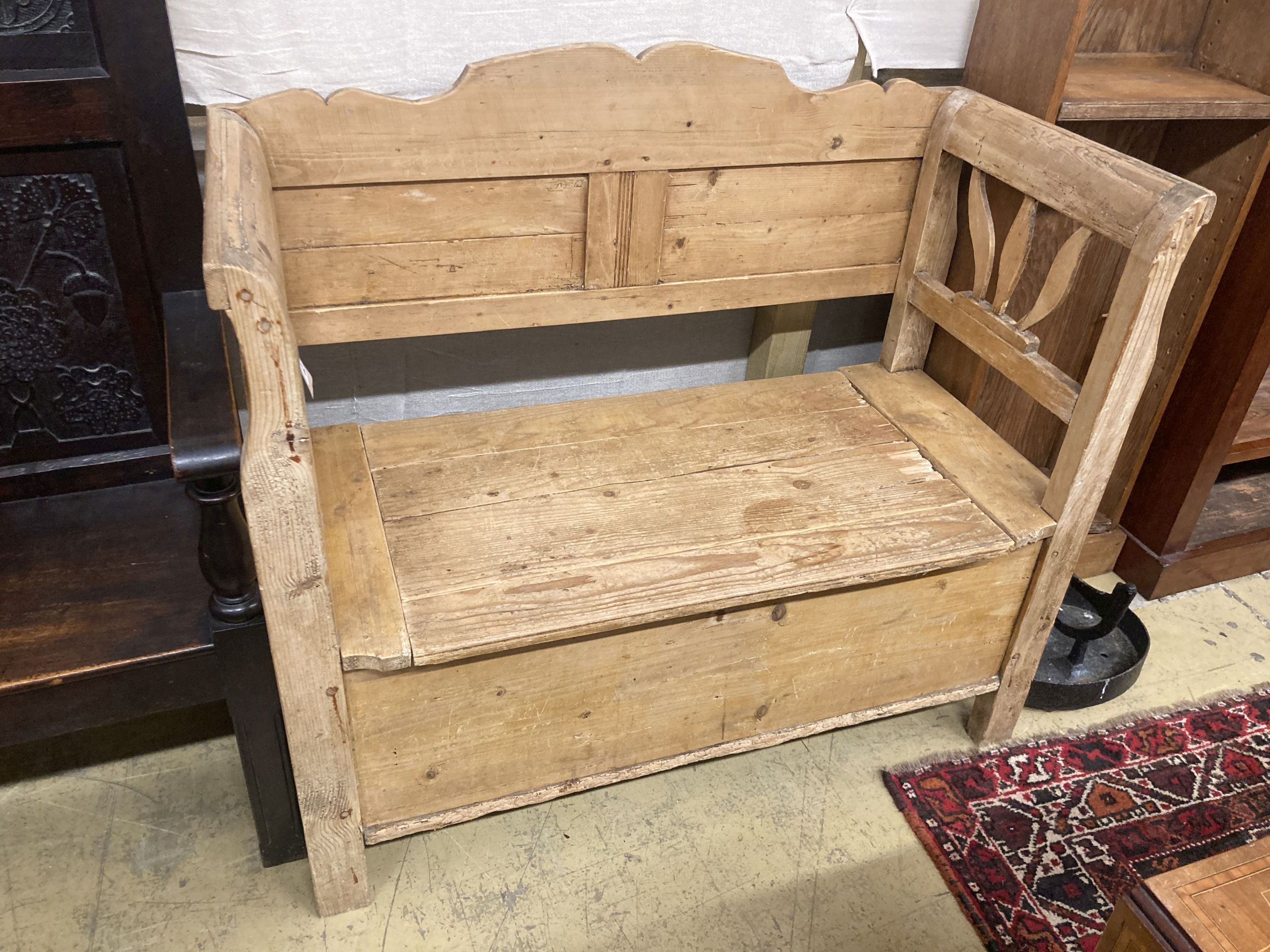A 19th century East European pine box seat settle, length 110cm, depth 50cm, height 98cm